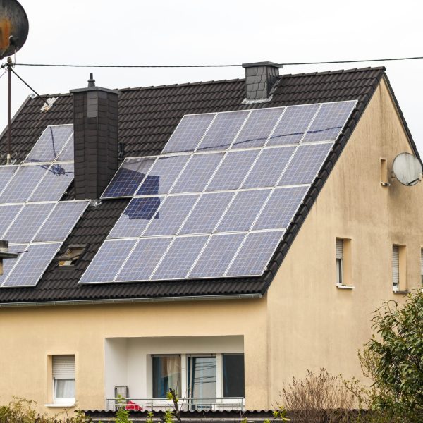 Renewable clean green energy saving efficient solar panels on suburban house roof.